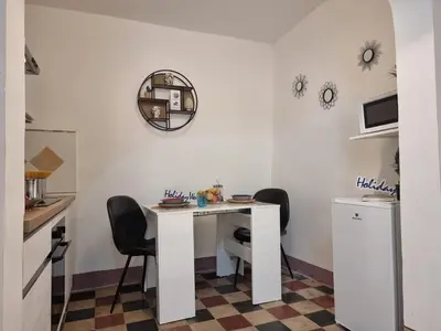 a kitchen with a white table and chairs at Donna Elisa by Holiday World in Carini
