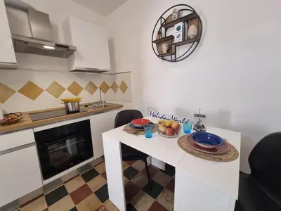 a kitchen with a table with a bowl of fruit on it at Donna Elisa by Holiday World in Carini