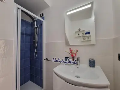 a white bathroom with a sink and a shower at Donna Elisa by Holiday World in Carini