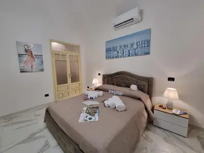 a bedroom with a bed with two stuffed animals on it at Donna Lidia by Holiday World in Carini
