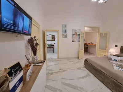 a living room with a flat screen tv on a wall at Donna Lidia by Holiday World in Carini
