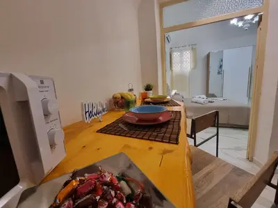 a kitchen with a table with a plate of food on it at Donna Lidia by Holiday World in Carini