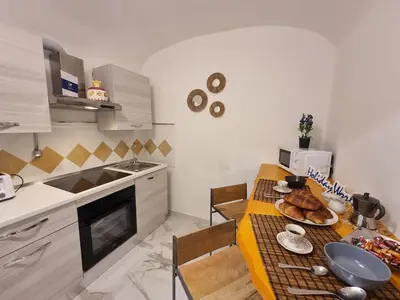 a kitchen with a table with a plate of food on it at Donna Lidia by Holiday World in Carini