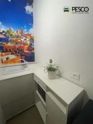 a white kitchen with a sink and a counter at Pesco Rooms Marineo in Marineo