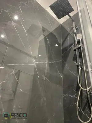 a bathroom with a shower with black marble walls at Pesco Rooms Marineo in Marineo