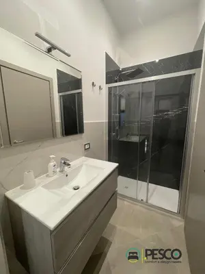 a white bathroom with a sink and a shower at Pesco Rooms Marineo in Marineo