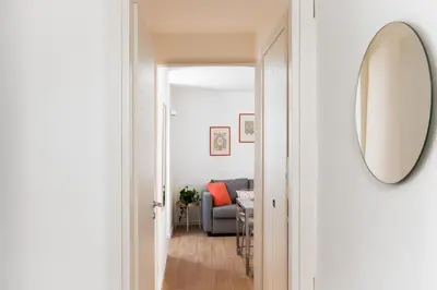 a hallway leading to a living room with a mirror at ControCanto Elegant Stay - 3 bedroom flat in Palermo