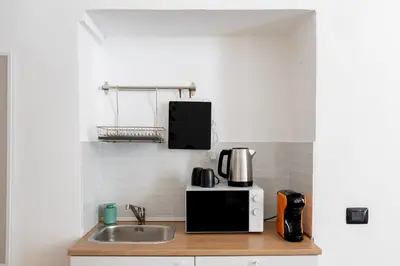 a kitchen with a sink and a microwave at ControCanto Elegant Stay - 3 bedroom flat in Palermo