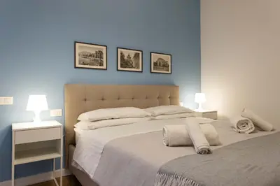 a bedroom with a bed with three pictures on the wall at Don Federico - For Couple in Palermo