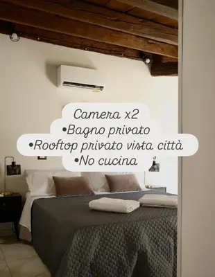 a bedroom with a bed with a sign on the wall at Sikelìa Apartment in Carini