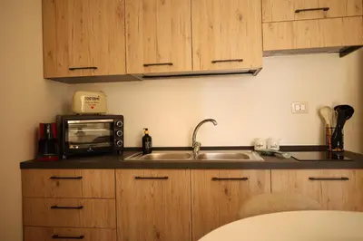 a kitchen with a sink and a microwave at Sikelìa Apartment in Carini
