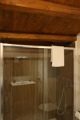 a shower with a glass door with a sink at Sikelìa Apartment in Carini