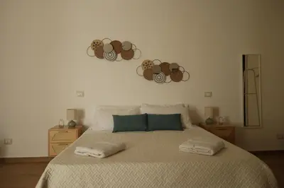 a bedroom with a large bed with twoousand at Sikelìa Apartment in Carini
