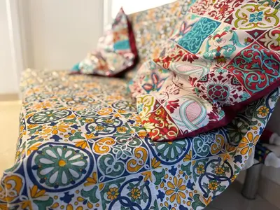 a bed with colorful pillows on top of it at The station house in Palermo