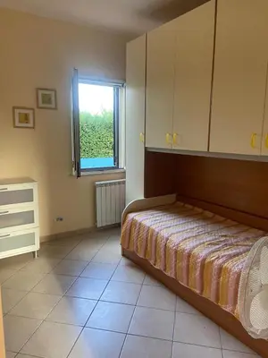 a bedroom with a bed and a window at La casa di Frank, con piscina privata in Campofelice di Roccella