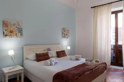 a bedroom with a white bed with stuffed animals on it at La Casa di Orlando Palermo in Palermo
