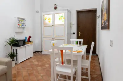 a dining room with a white table and chairs at La Casa di Orlando Palermo in Palermo