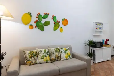 a couch in a living room with a wall at La Casa di Orlando Palermo in Palermo