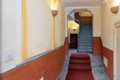 a hallway with stairs and a red carpet at La Casa di Orlando Palermo in Palermo