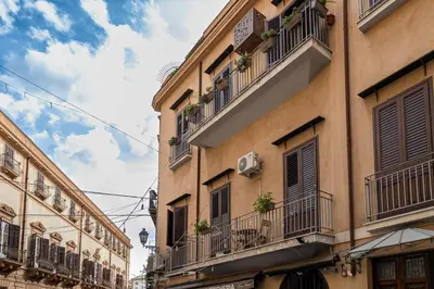 a couple of buildings with balconies and plants on them at La Casa di Orlando Palermo in Palermo