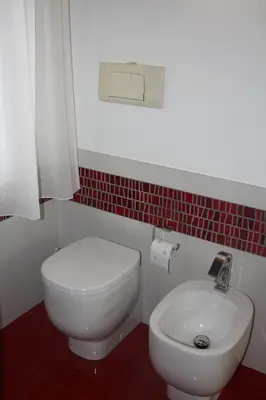a bathroom with a white toilet and a sink at Imbriani103 in Cinisi
