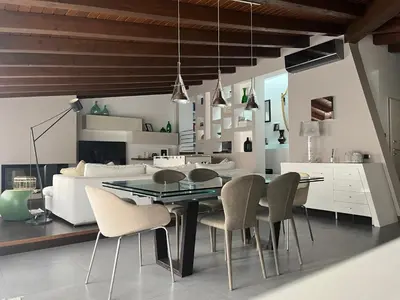 a dining room with a black table and chairs at Imbriani103 in Cinisi