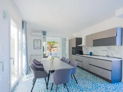 a kitchen and dining room with a table and chairs at Villa Verde Essence in Castellammare del Golfo