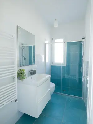 a bathroom with a sink and a toilet and a shower at Villa Verde Essence in Castellammare del Golfo