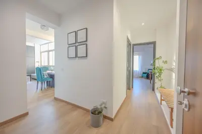 an empty room with a hallway with a table and chairs at Taléa - Design Apartment a Palermo in Palermo