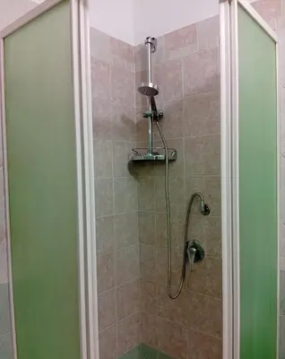 a shower with a glass door in a bathroom at Sicilia Bedda Casa Vacanze in Lascari