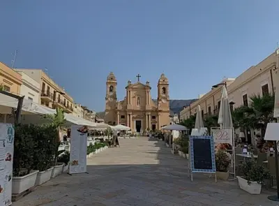 an empty street with a church in the background at A casa dei nonni in Terrasini