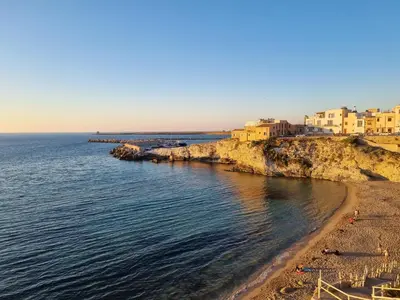 a view of a beach with buildings and the water at A casa dei nonni in Terrasini