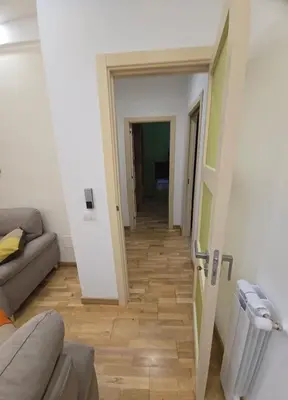 a hallway leading to a living room with a couch at La Casa di MaMA in Palermo