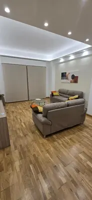a living room with two couches and a table at La Casa di MaMA in Palermo