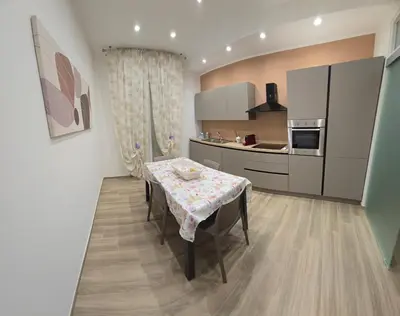 a kitchen with a table with a table cloth on it at La Casa di MaMA in Palermo