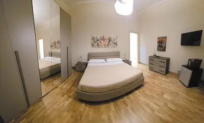 a bedroom with a large bed and a large mirror at La Casa di MaMA in Palermo