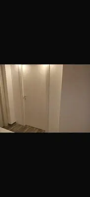 a small room with a white door and a hallway at La casetta del Maggiore 3 in Palermo