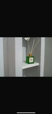 a white shelf with a flower in a box on it at La casetta del Maggiore 3 in Palermo