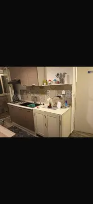 a kitchen with white cabinets and a counter top at La casetta del Maggiore 3 in Palermo