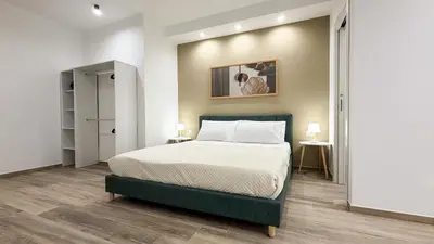 a bedroom with a large bed in a room at Street316 in Cinisi