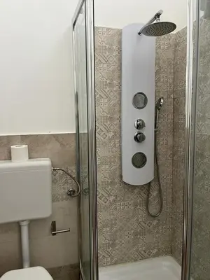a bathroom with a shower with a toilet at Camera Verga in Palermo