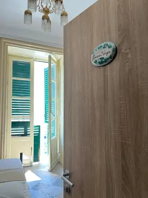 a room with a bed and a plate on the wall at Camera Verga in Palermo