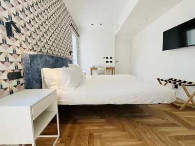 a bedroom with a bed and a tv on a wall at Design Villa with private pool in Carini