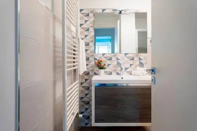 a bathroom with a sink and a mirror at VILLA DEI SOSPIRI 4, Emma Villas in Castellammare del Golfo