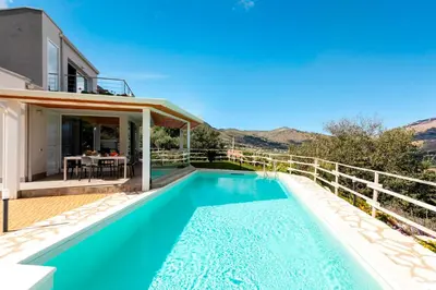 a villa with a swimming pool and a house at VILLA DEI SOSPIRI 4, Emma Villas in Castellammare del Golfo