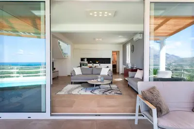 a living room with a view of the ocean at VILLA DEI SOSPIRI 4, Emma Villas in Castellammare del Golfo