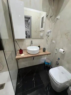 a bathroom with a sink and a toilet at Kamel home in Palermo