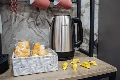 a coffee pot sitting on top of a table with snacks at Kamel home in Palermo