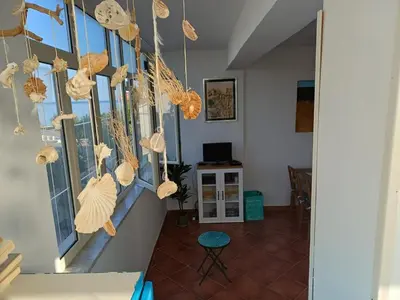 a hallway with shells hanging on the wall at Villa sul mare in Isola delle Femmine