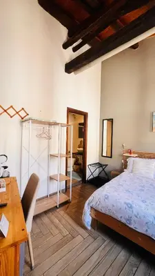 a bedroom with a bed and a desk and a desk at Kasa Kaletta Rooms in Palermo